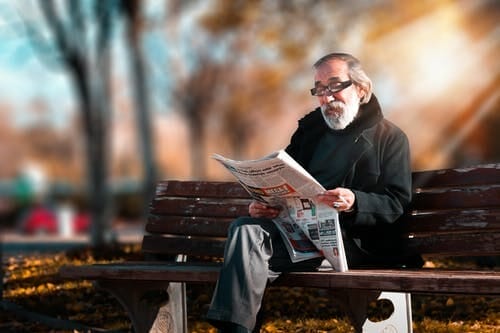 Older gentleman in a park reading